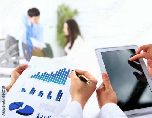 Photo: busienssman holding digital tablet in office busienssman holding digital tablet in office