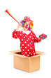 Foto: Playful clown coming out of a box and holding a horn and a prese Playful clown coming out of a box and holding a horn and a prese