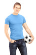 Foto: Young handsome man holding a soccer ball Young handsome man holding a soccer ball