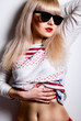 Portrait of a beautiful and young blonde in sunglasses