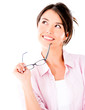 Photo: Thoughtful woman holding glasses Thoughtful woman holding glasses