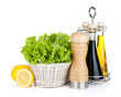 Lettuce in basket with lemon fruits, pepper shaker, olive oil an