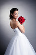 Portrait of attractive bride posing with bouquet