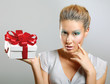 Girl opening x-mass present isolated on grey background
