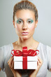 Girl opening x-mass present isolated on grey background