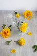 glass goblet and yellow roses on the light board