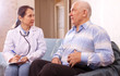 Mature man complaining  to doctor about tummy-ache