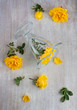 top view on the glass and yellow roses