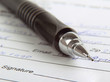 Sign the name on a paper with a pen