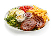 Photo: Grilled steaks, French fries and vegetables Grilled steaks, French fries and vegetables