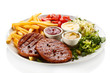 Foto: Grilled steaks, French fries and vegetables Grilled steaks, French fries and vegetables