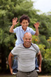 Mixed race father and son playing in the back garden