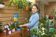 woman  surrounded by different flowers in  store