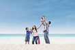 Photo: Asian family at white sand beach Asian family at white sand beach