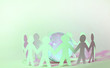 Team of paper doll people holding hands