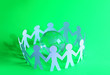 Team of paper doll people holding hands