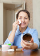Mature woman removes makeup