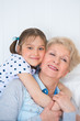 Photo: Lovely little girl with her grandmother having fun and happy mom Lovely little girl with her grandmother having fun and happy mom