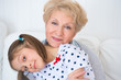 Photo: Lovely little girl with her grandmother having fun and happy mom Lovely little girl with her grandmother having fun and happy mom