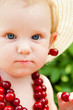 child with cherry beads