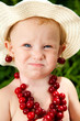 child with cherry beads