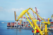 Container stack and ship under crane bridge