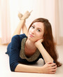 Photo: Young woman lying on the floor and smiling Young woman lying on the floor and smiling
