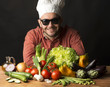 cook with vegetables on black background