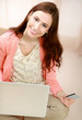 Photo: Young woman sitting on thr floor with laptop Young woman sitting on thr floor with laptop