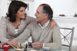 Foto: Married couple playing chess at home Married couple playing chess at home