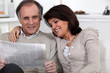 Couple reading newspaper