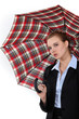 Young woman in suit with an umbrella