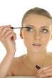 Woman applying makeup