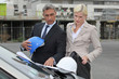 Photo: Male and female architects stood by car Male and female architects stood by car