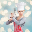 Woman in chef's hat “firing a gun” with the mixer