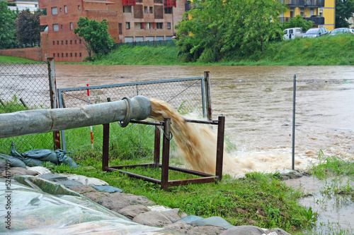Photo: impressive exhaust flows into river rainwater and mud impressive exhaust flows into river rainwater and mud