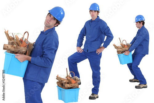Photo: construction worker carrying recyclable material construction worker carrying recyclable material