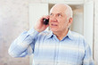 mature man speaks by phone