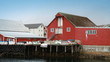 Red wooden houses and packed fishing nets