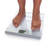 Photo: Low Section Of A Young On A Weighing Scale Low Section Of A Young On A Weighing Scale