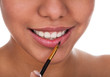 Photo: Young Woman Applying Lipstick Young Woman Applying Lipstick