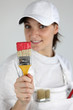 Foto: Painter with a paintbrush in her hand Painter with a paintbrush in her hand