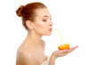 Attractive smiling young woman drinking orange juice