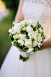 Wedding bouquet in hands of the bride