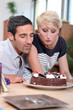 Photo: Couple blowing birthday candle Couple blowing birthday candle