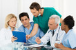 Photo: Team Of Doctors Examining Reports Team Of Doctors Examining Reports