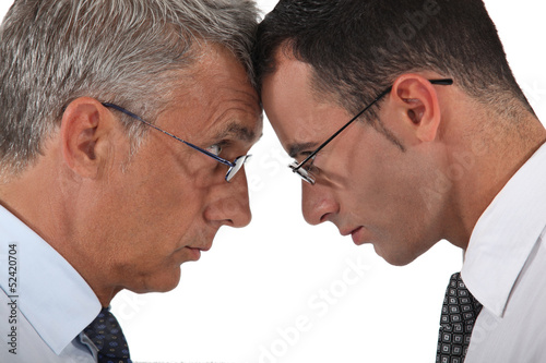 Photo: Businessmen head to head Businessmen head to head