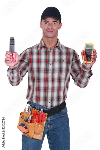 Photo: Man holding wire clipper and electrical current measure Man holding wire clipper and electrical current measure