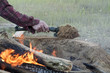 Man Builds Fire Pit Around Open Camp Fire