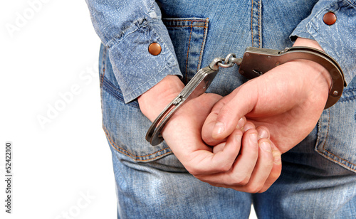 Photo: Handcuffs on Hands closeup Handcuffs on Hands closeup